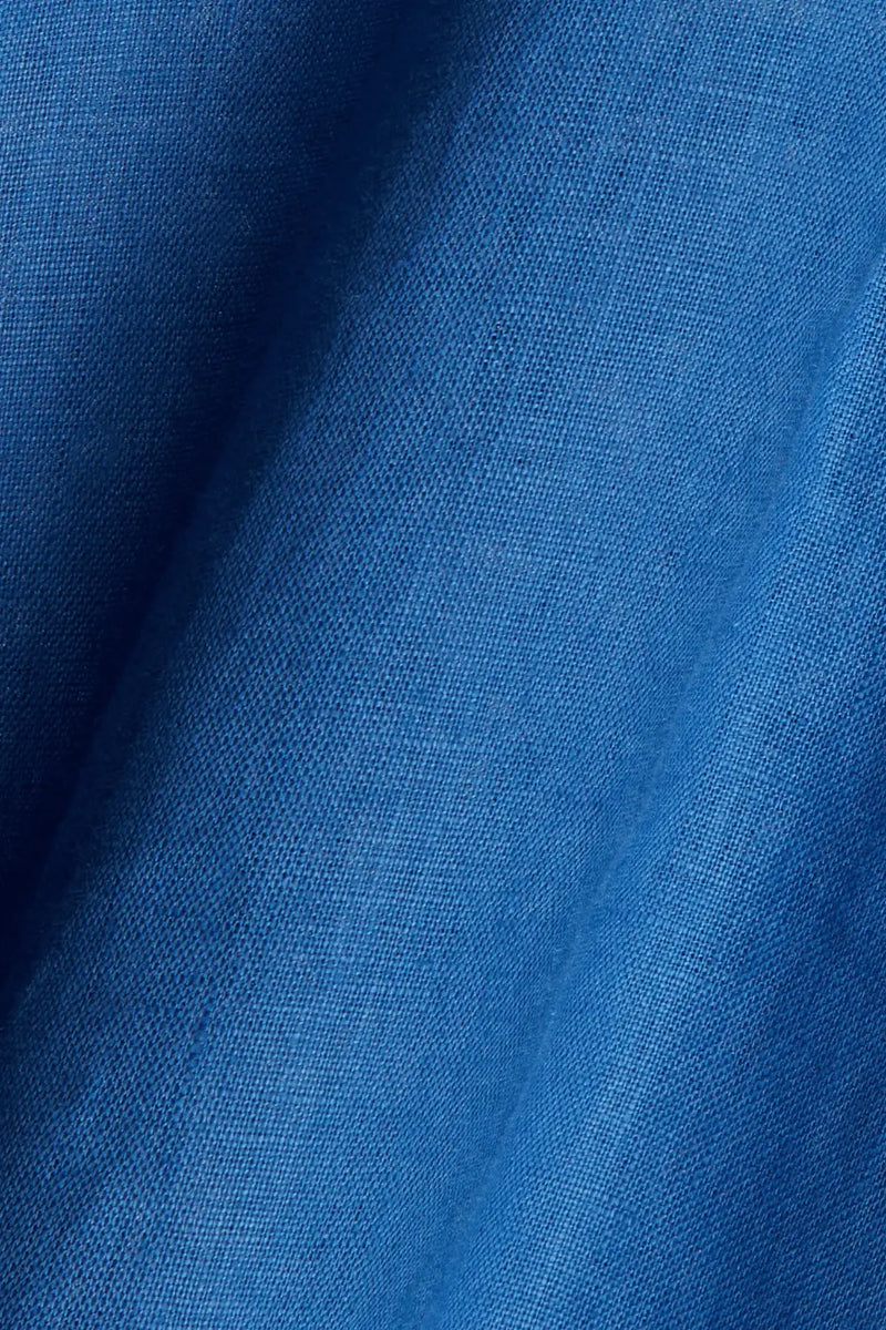 Fabric close-up of Anna Bey's signature blue linen shirt dress