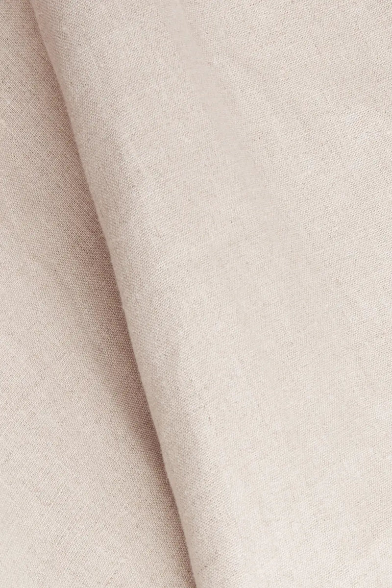 Fabric close-up of Anna Bey's signature linen shirt dress in oatmeal