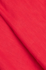 Fabric close-up of Anna Bey's signature linen shirt dress in red