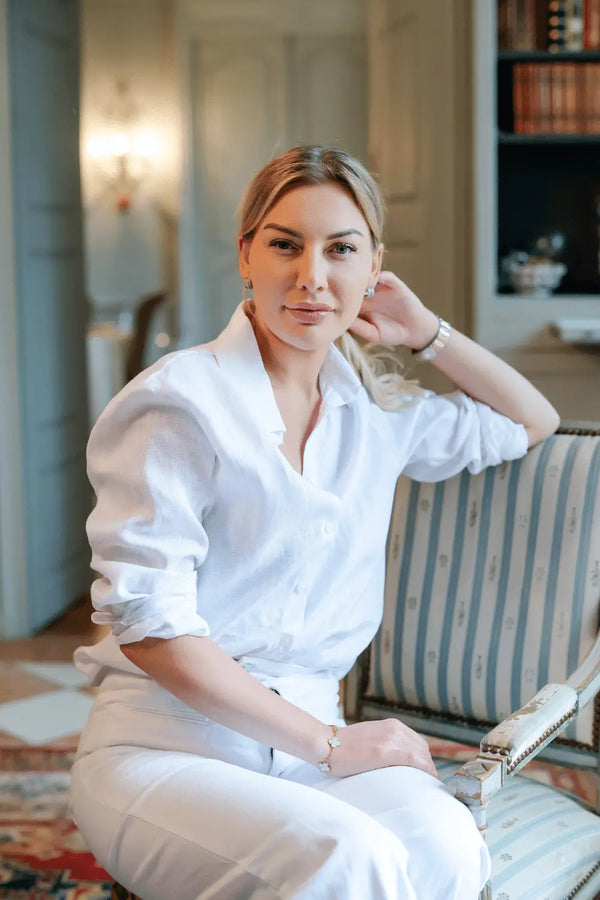 Anna Bey wearing a long-sleeved linen shirt in white